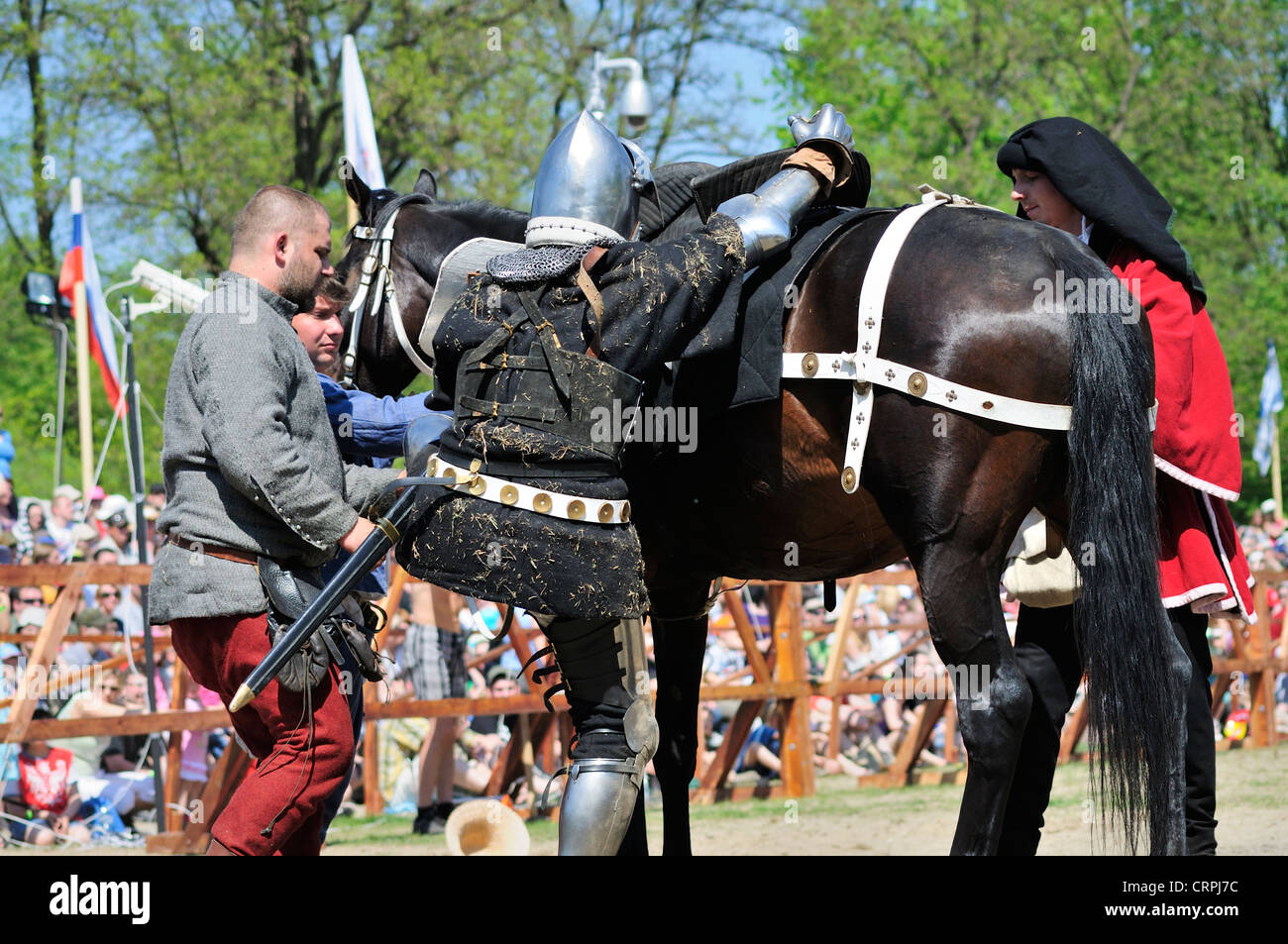 Knight mounting horse Stock Photo