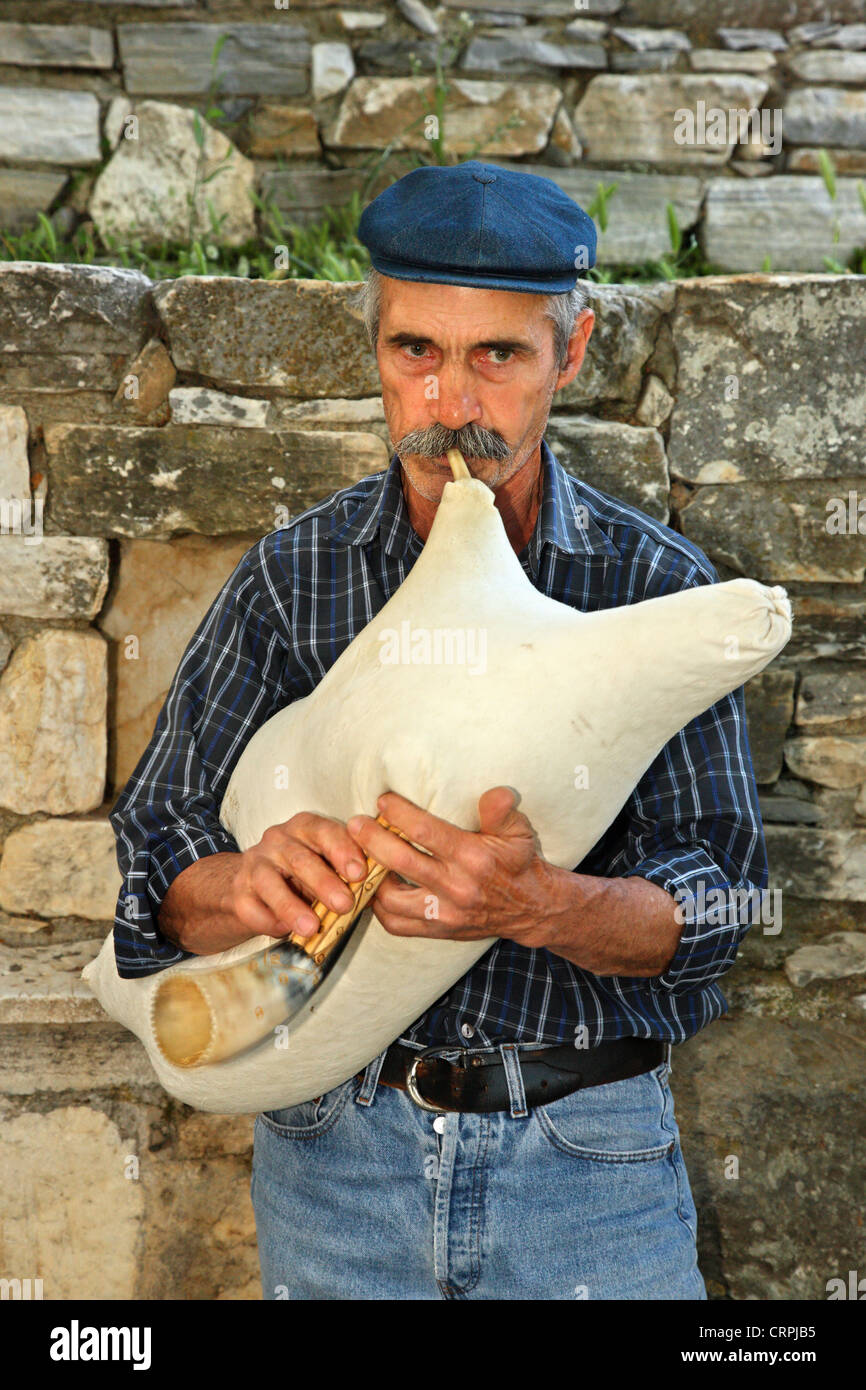 Musician from Filoti village (Naxos island, Cyclades, Aegean sea, Greece), playing the tsambuna (local bagpipe) Stock Photo