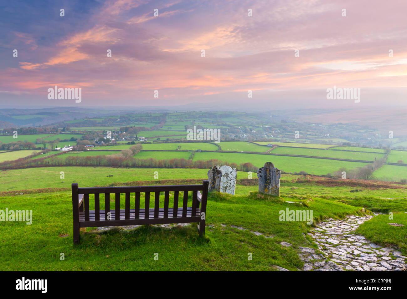 View from a bench by the Church of St Michael on top of Brent Tor, over the rural Dartmoor landscape. Stock Photo