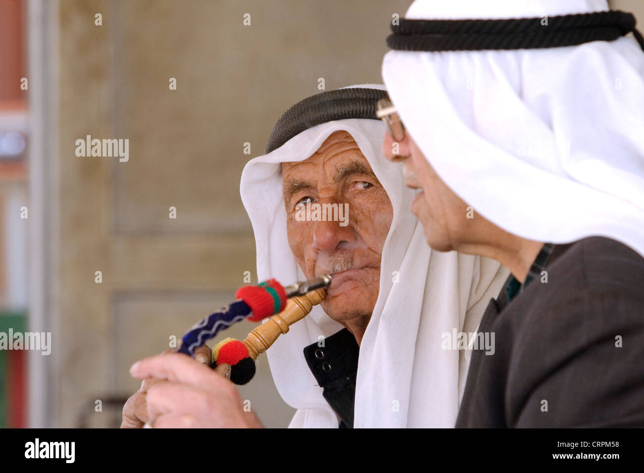 Arab men smoke sheesha pipes in the Old City's Muslim Quarter, Jerusalem, Israel Stock Photo