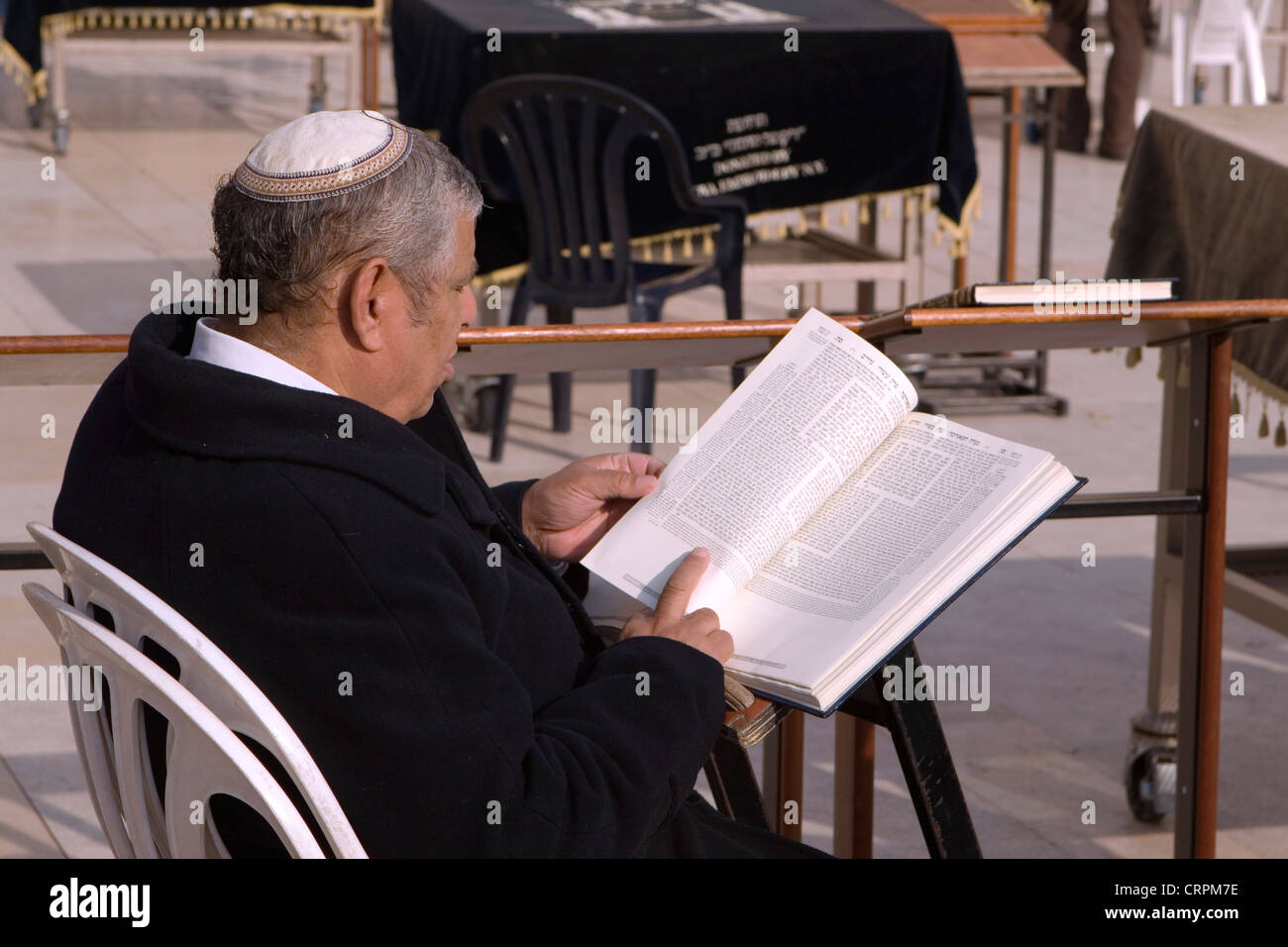 Jewish man reads from the Torah at the Old City's Western Wall, Jerusalem, Israel Stock Photo