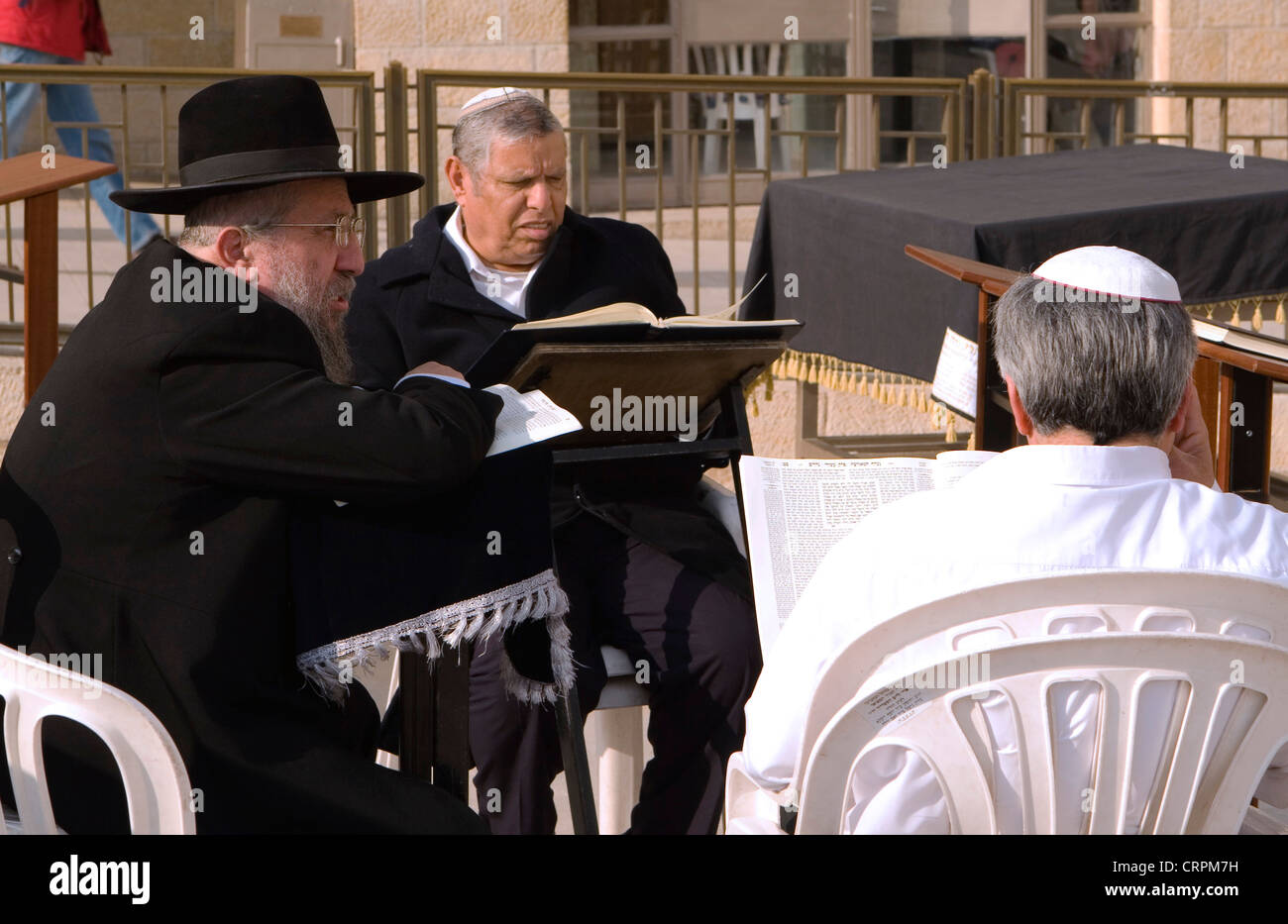 Jewish men read and discuss the Torah at the Old City's Western Wall, Jerusalem, Israel Stock Photo