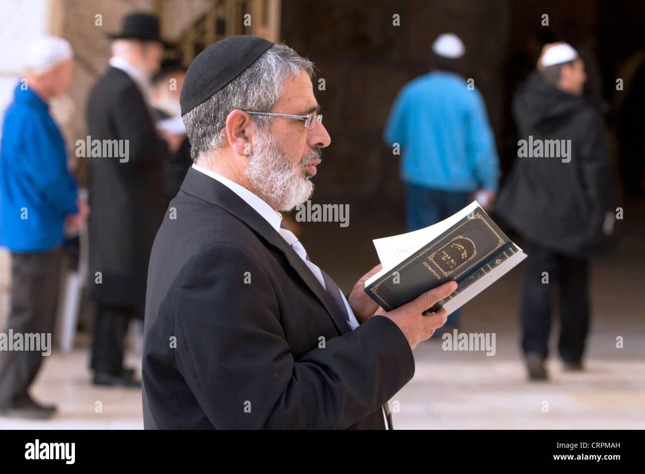 Jewish man reads the Torah at the Old City's Western Wall, Jerusalem, Israel Stock Photo
