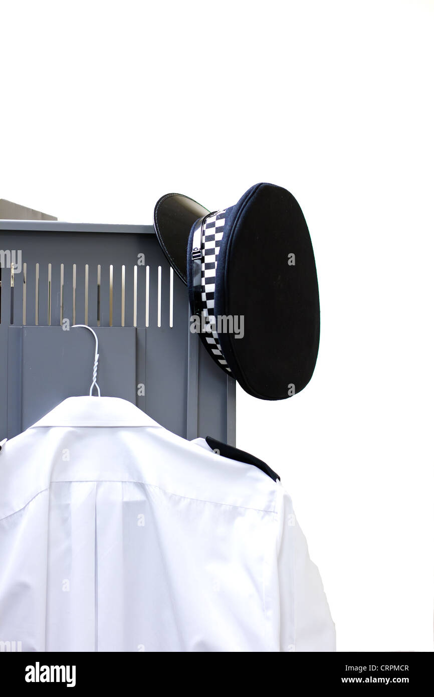 policeman's hat and shirt hanging on a locker door Stock Photo