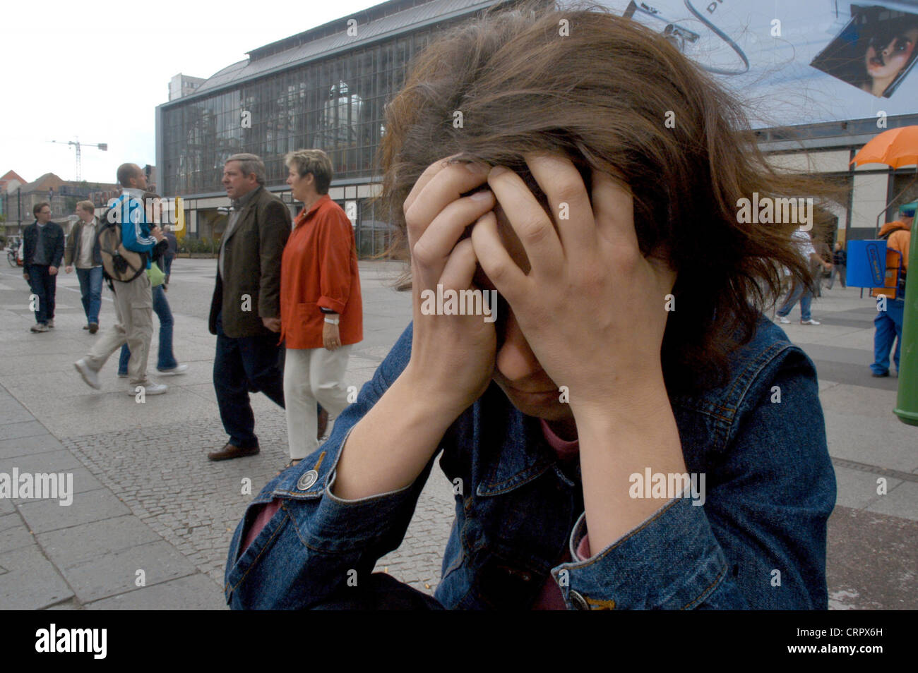 Desperate woman hides her face, Berlin Stock Photo - Alamy