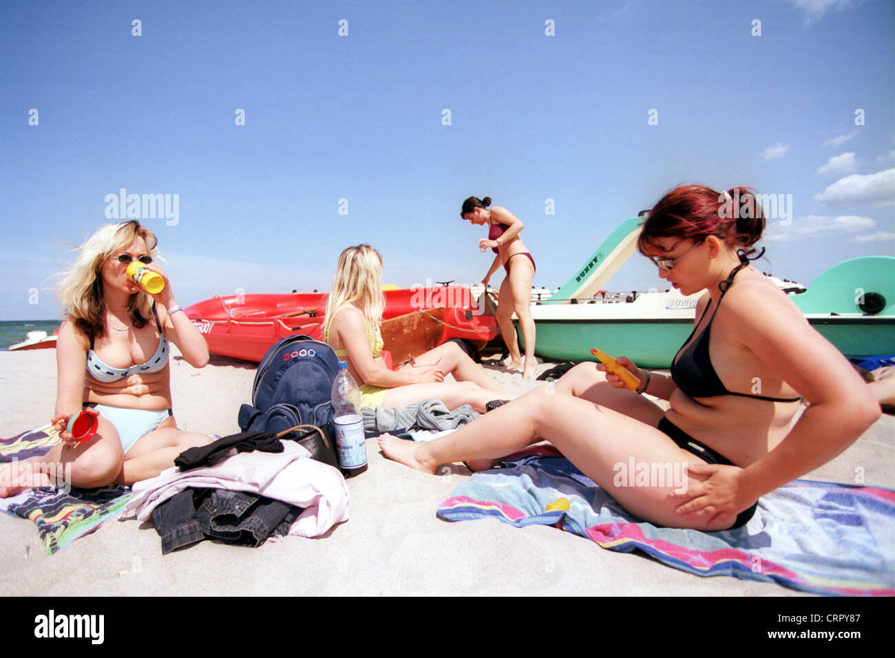 Women sun themselves on the beach of the Baltic Sea Stock Photo