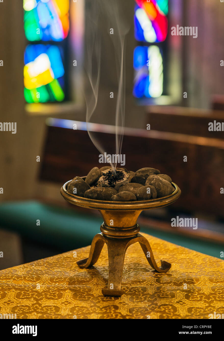 Incense burns in monastic chapel. Stock Photo