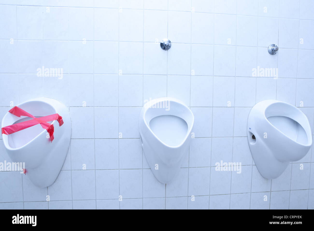 out of order concept - man restroom with three urinals/pissoirs out of