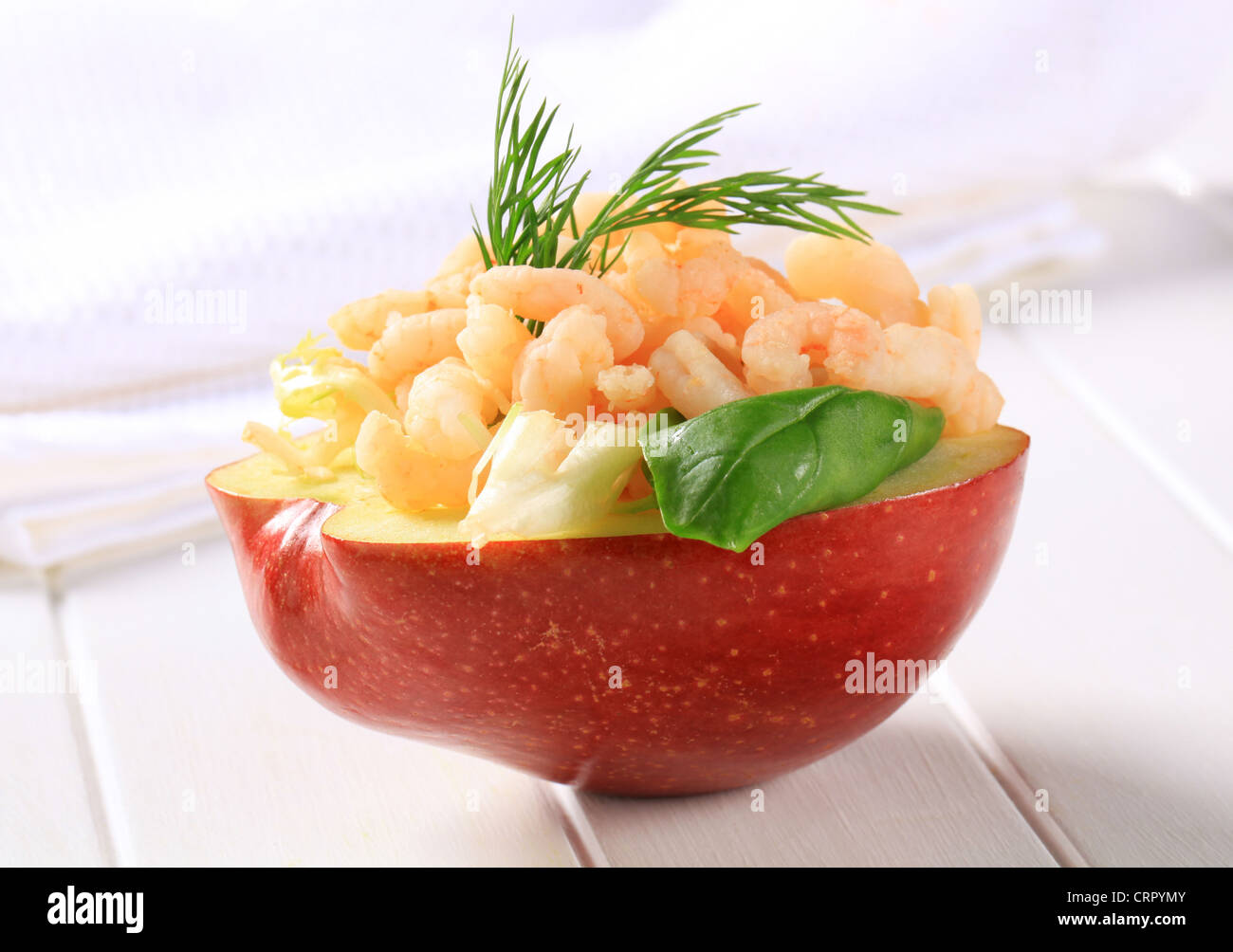 Half apple topped with shrimps Stock Photo