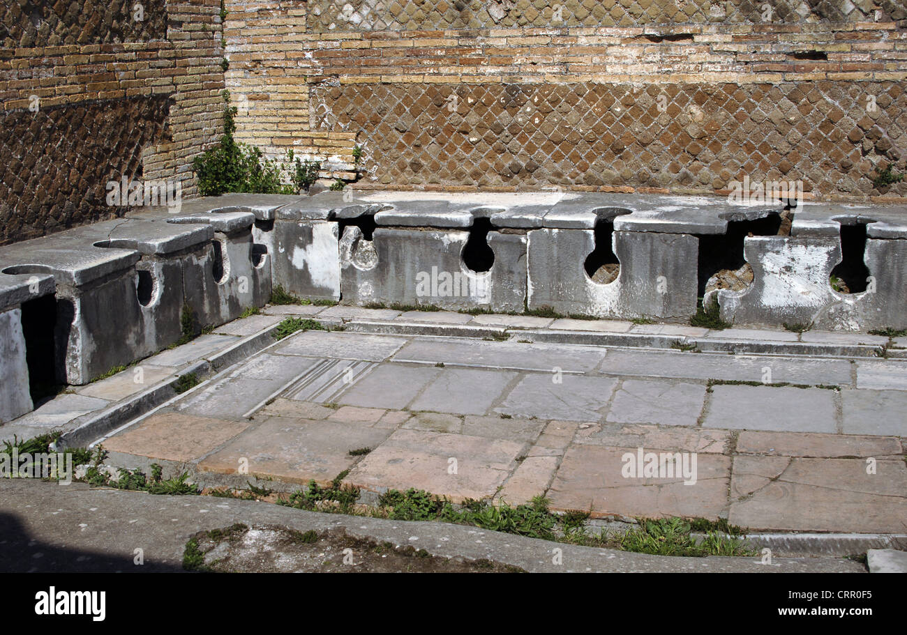 Ostia Antica. Latrine at the Domus of Triclini, headquarters of the guild of builders. 2nd century AD. Near Rome. Stock Photo