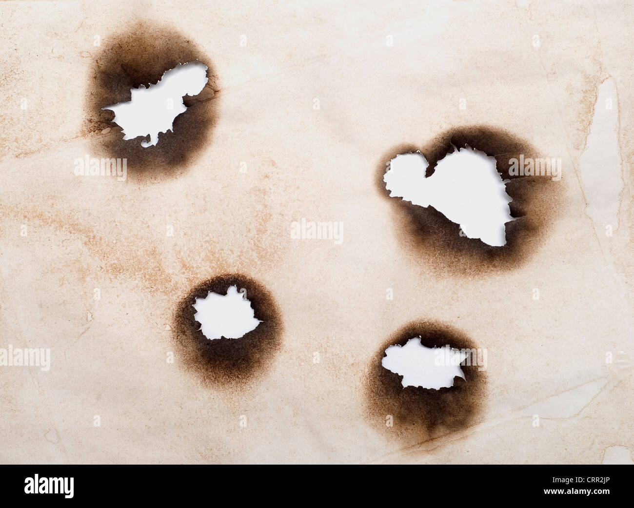 burnt holes in a grunge paper Stock Photo Alamy