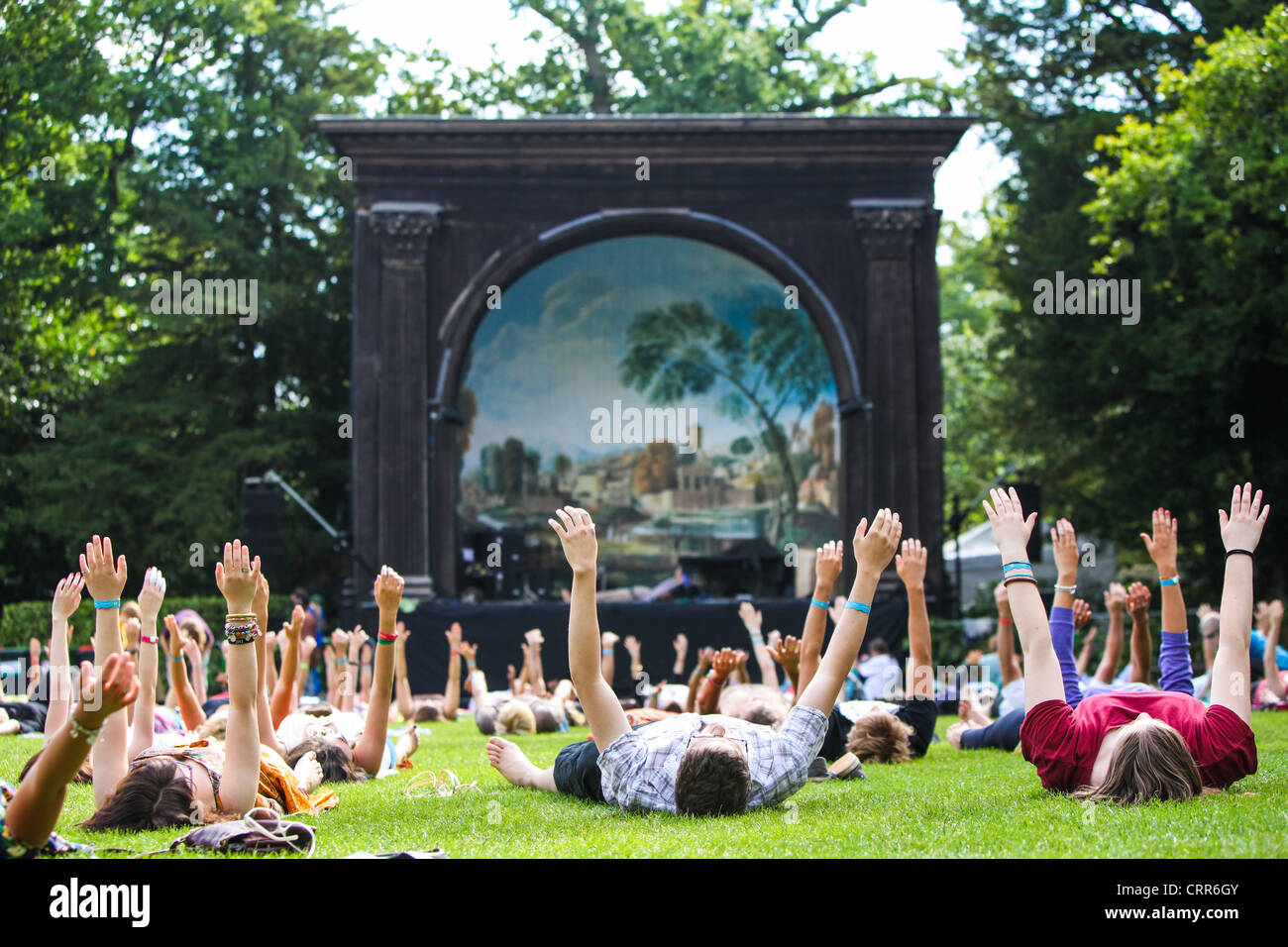 Early morning yoga in front of the main stage at the Larmer Tree Music festival 2011, UK Stock Photo