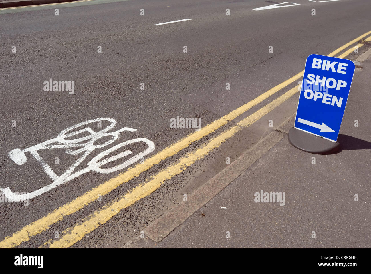 bike shop open sign adjacent to cycle lane marking, kingston upon