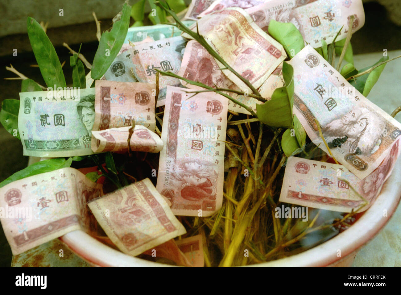 Chinese banknotes in a donation pot Stock Photo Alamy