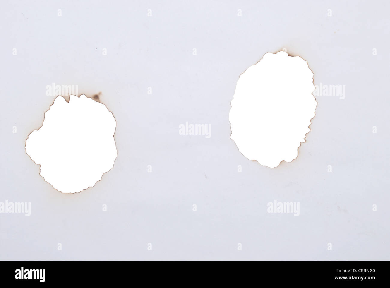 burnt holes in a paper Stock Photo Alamy