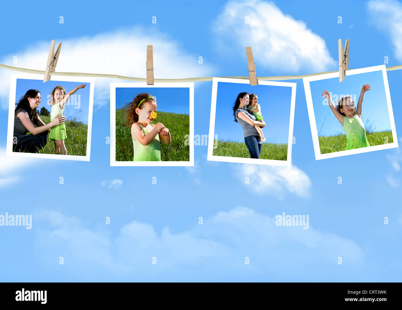 Family photographs hanging on a clothesline against a blue sky Stock Photo