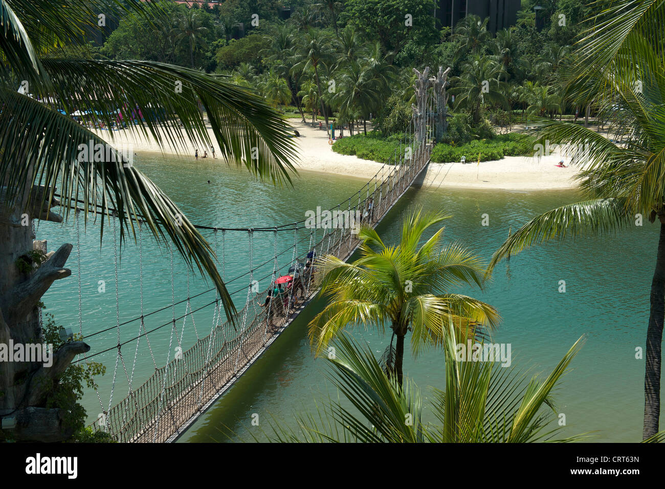 Swinging foot bridge linking Palawan beach on Sentosa island to the southernmost point of continental Asia, Singapore Stock Photo