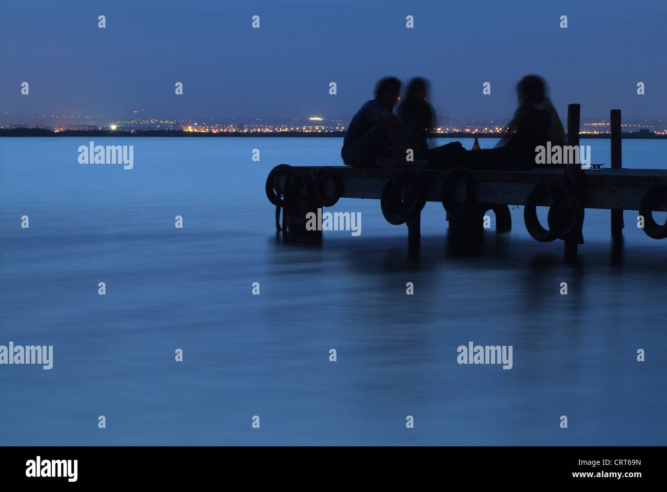 Young sitting on the dock of the Albufera, El Saler, Valencia, Spain, Europe Stock Photo