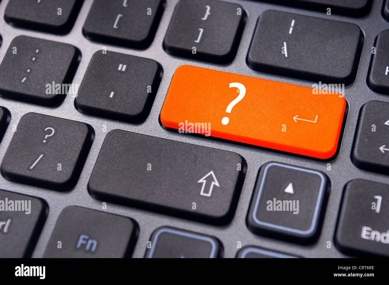 concepts of questions or computer errors, with a question on enter key of keyboard. Stock Photo