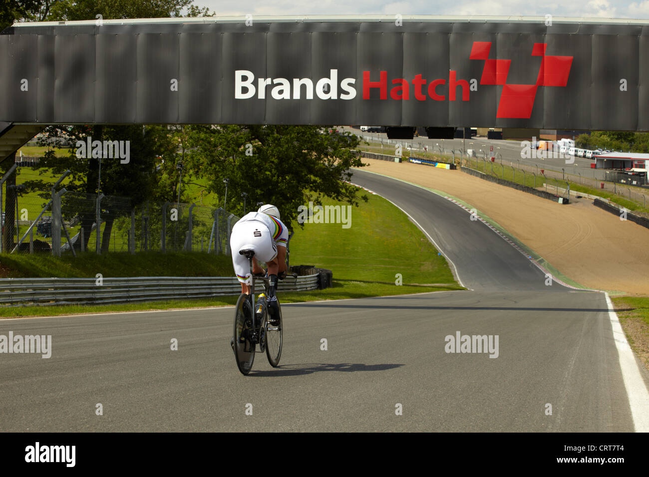 Para-cyclist going under the bridge and down Hailwood Hill at Brands Hatch during training session. Stock Photo