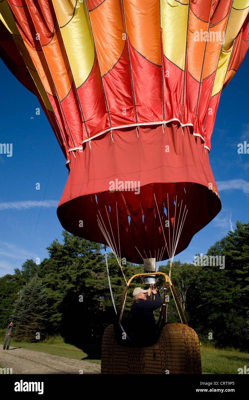 Hot air balloon pilot prepares to deflate balloon after landing in western Massachusetts. Stock Photo