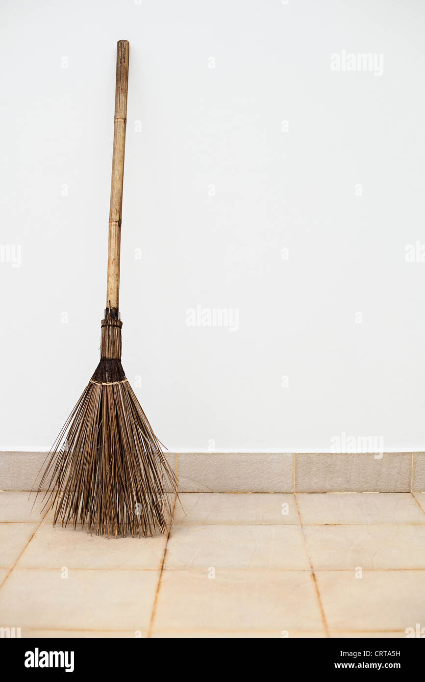 A large a broom near a white wall Stock Photo