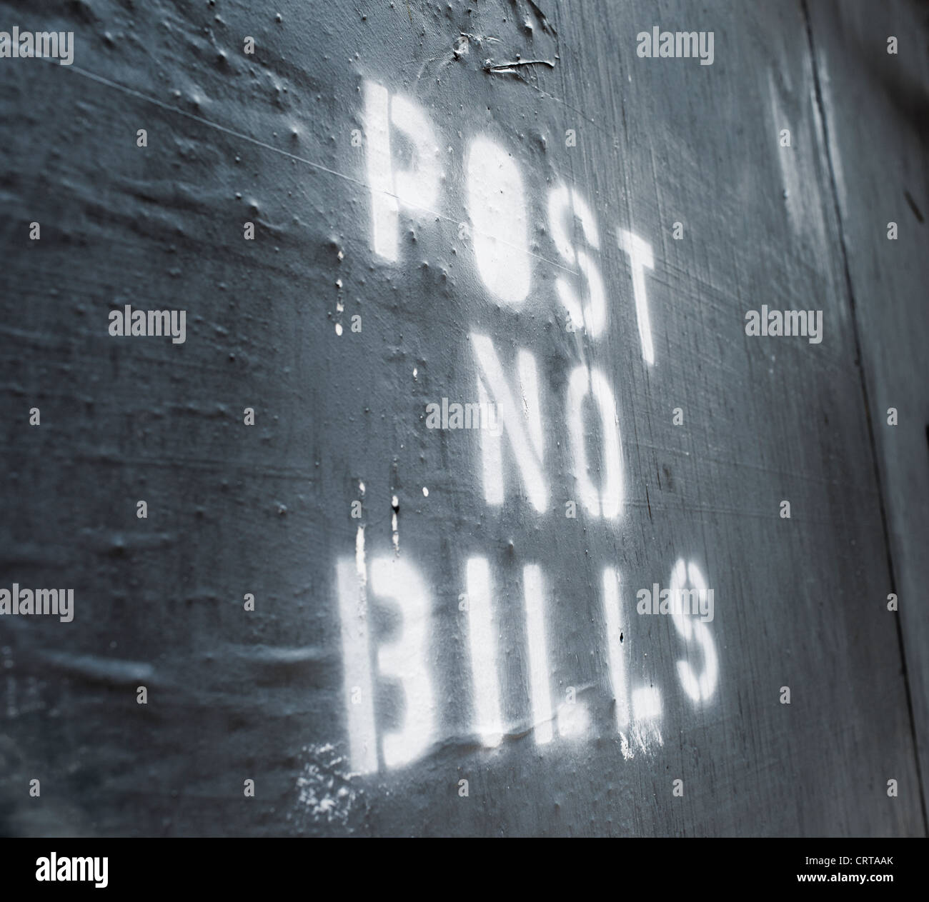 Words 'Post No Bills' sprayed on an old wall. Stock Photo