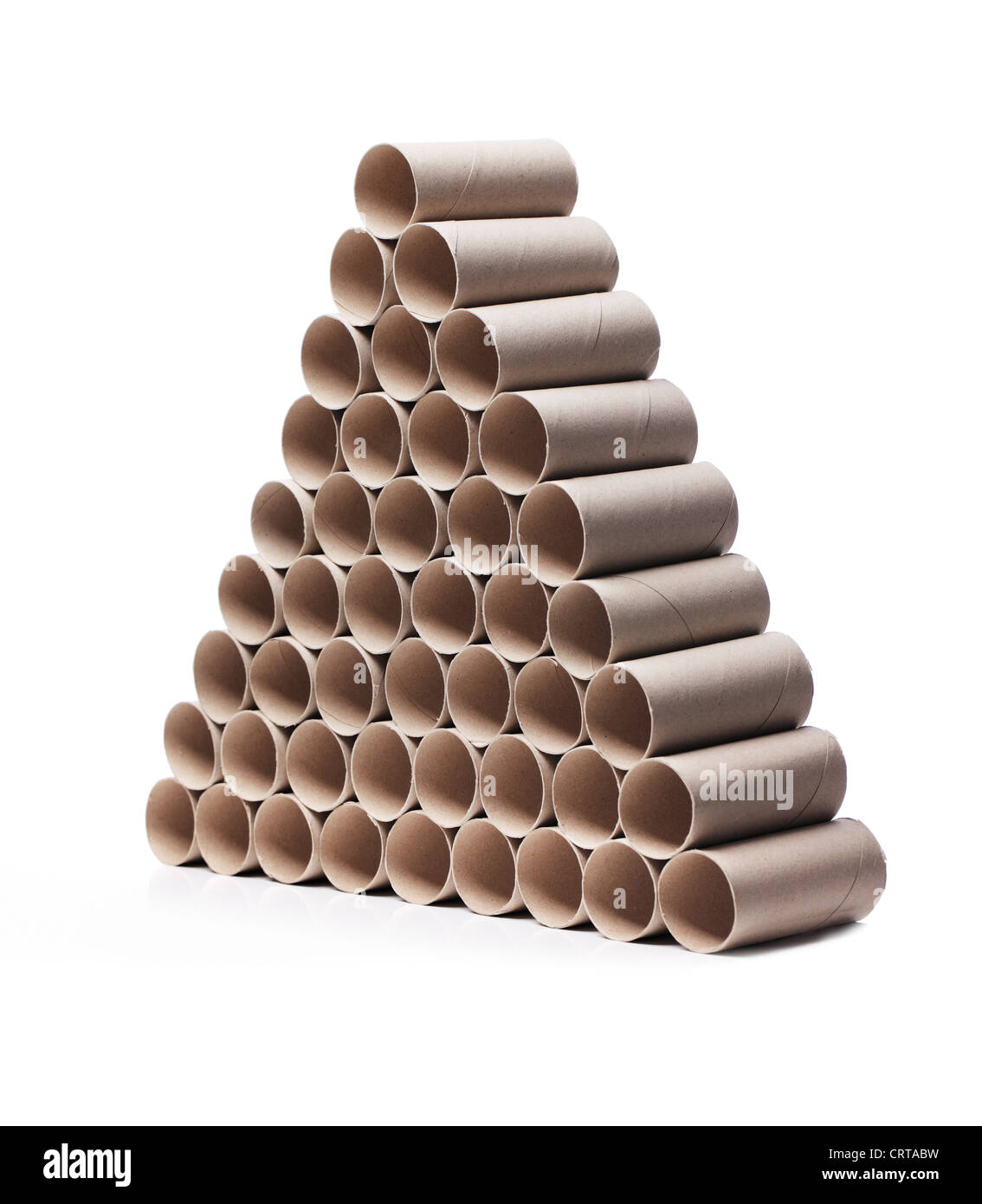 Used toilet paper cardboard rolls stacked in a triangular fashion. Stock Photo