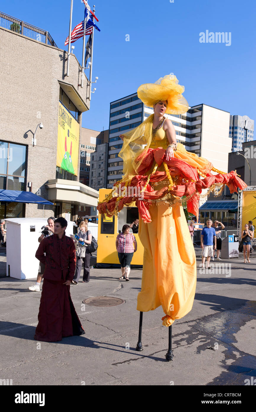 Stilt artist walking amongst people during the Just for Laughs festival