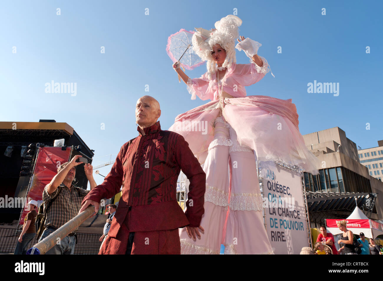 Stilt artist walking amongst people during the Just for Laughs festival
