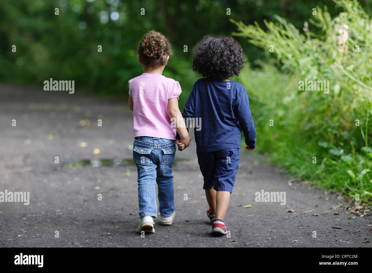 Boy and Girl Holding Hands Stock Photo - Alamy
