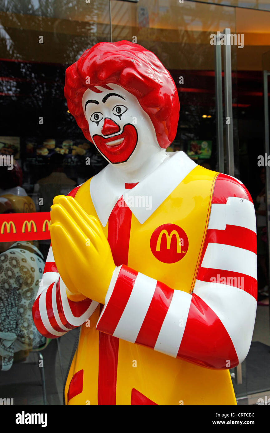 Ronald McDonald statue making Thai greeting Sawasdee in Bangkok, Thailand. Stock Photo