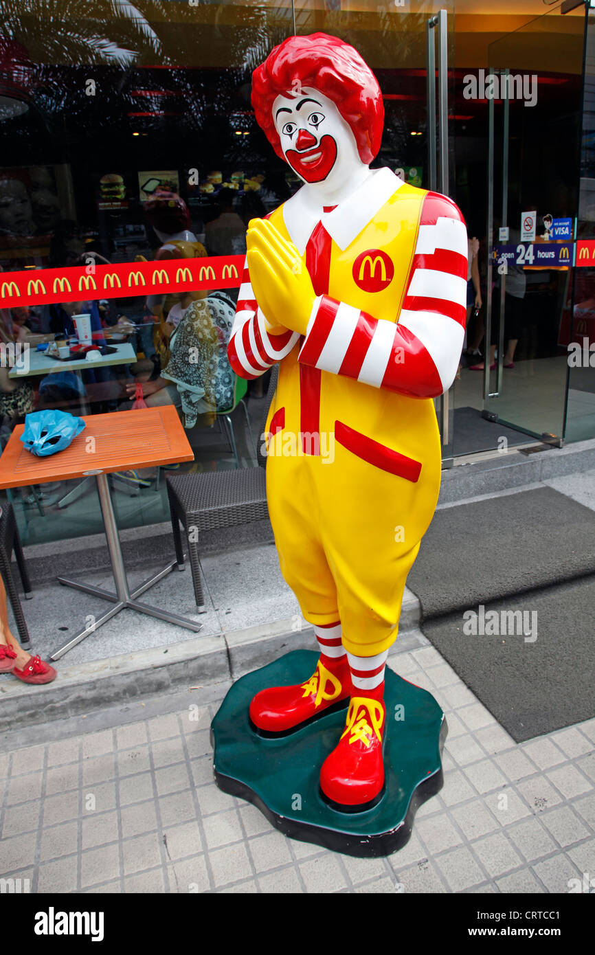 Ronald McDonald statue making Thai greeting Sawasdee in Bangkok, Thailand. Stock Photo