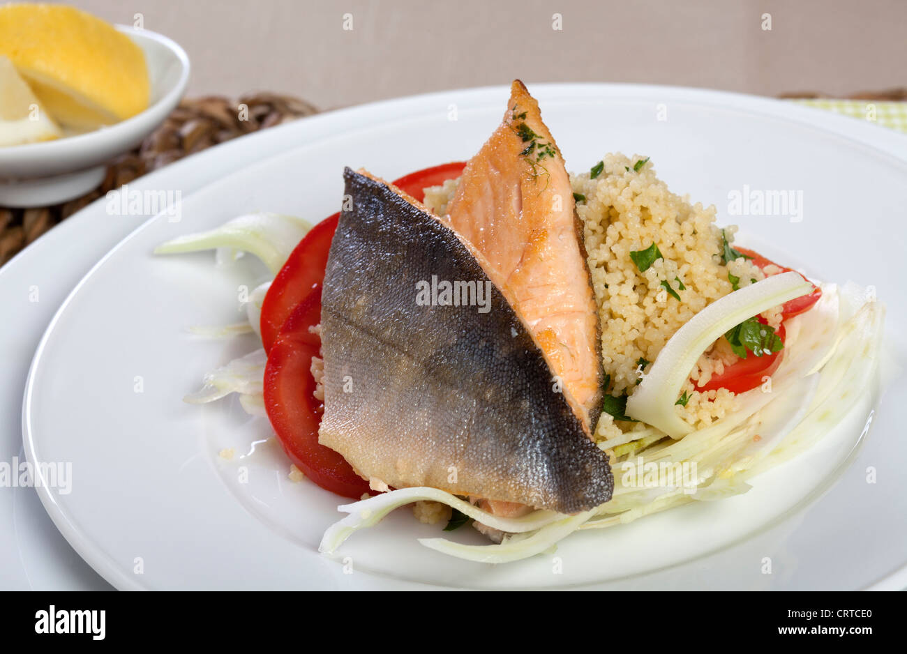 Grilled Arctic Char on Couscous, Fennel and Tomatos Stock Photo - Alamy