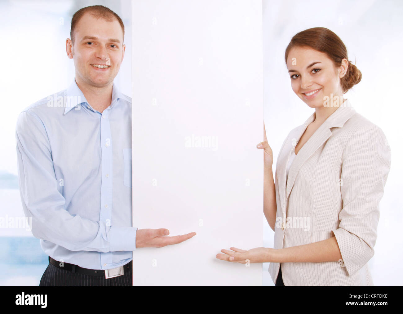 Two successful contemporary businesspeople, with a white banner Stock Photo