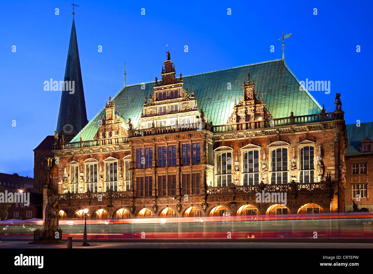 Townhall in Bremen at the blue hour. In the foreground a tram passing by. Long exposure - motion blur. Stock Photo