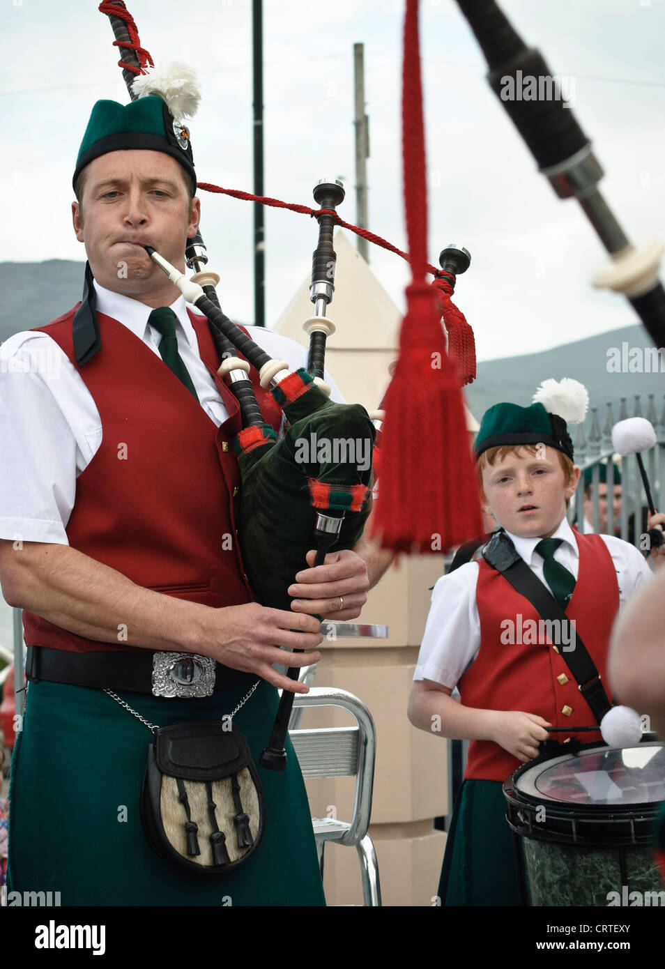 26th June, 2011. Warrenpoint, Northern Ireland. Members of a marching band both young and not so young play drums and a bagpipe. Stock Photo