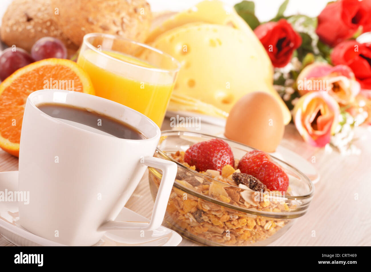 Breakfast on the table. Coffee, orange juice, rolls, muesli. Stock Photo