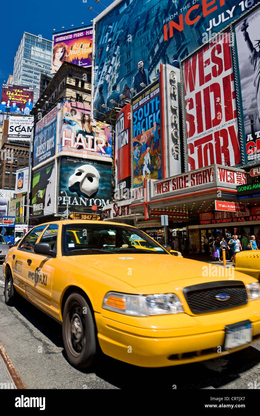 Taxi New York Times Square Yellow Taxi, New York City Daytime Broadway Theater Billboards and Yellow Taxis Stock Photo