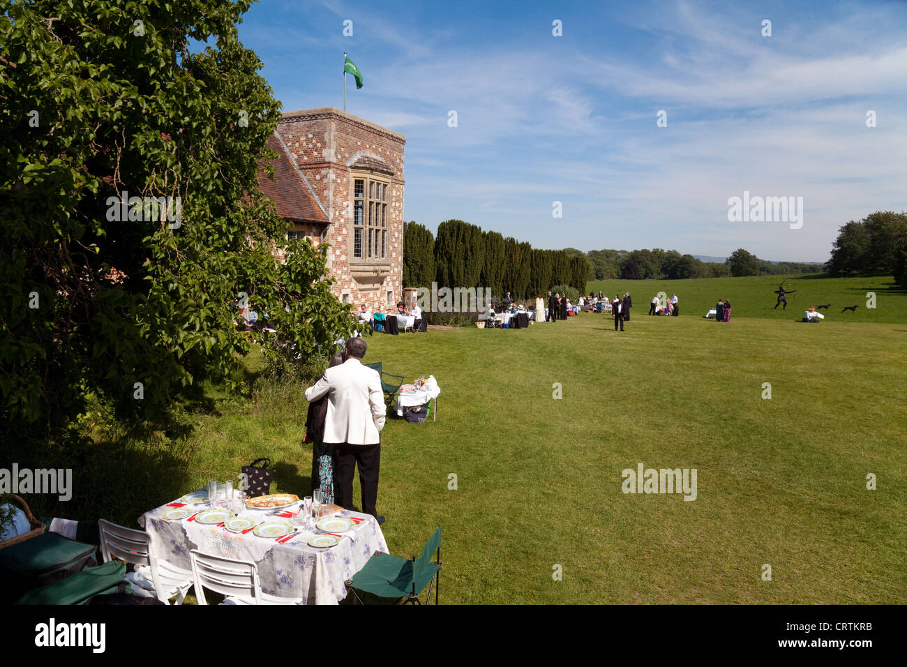 People having a picnic on the lawns at the Glyndebourne opera festival, Lewes, Sussex UK Stock Photo