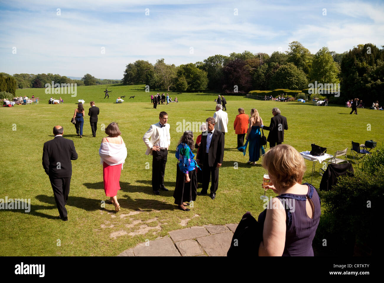 People dressed up on the lawns at the Glyndebourne opera festival, Lewes, Sussex UK Stock Photo