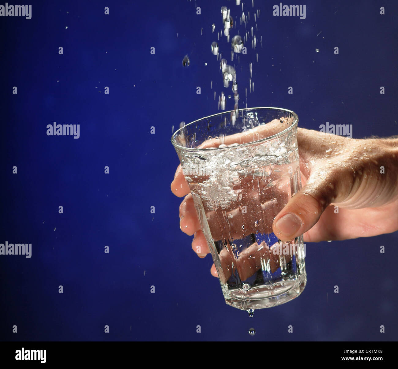 Hand with glass absorbs water Stock Photo Alamy