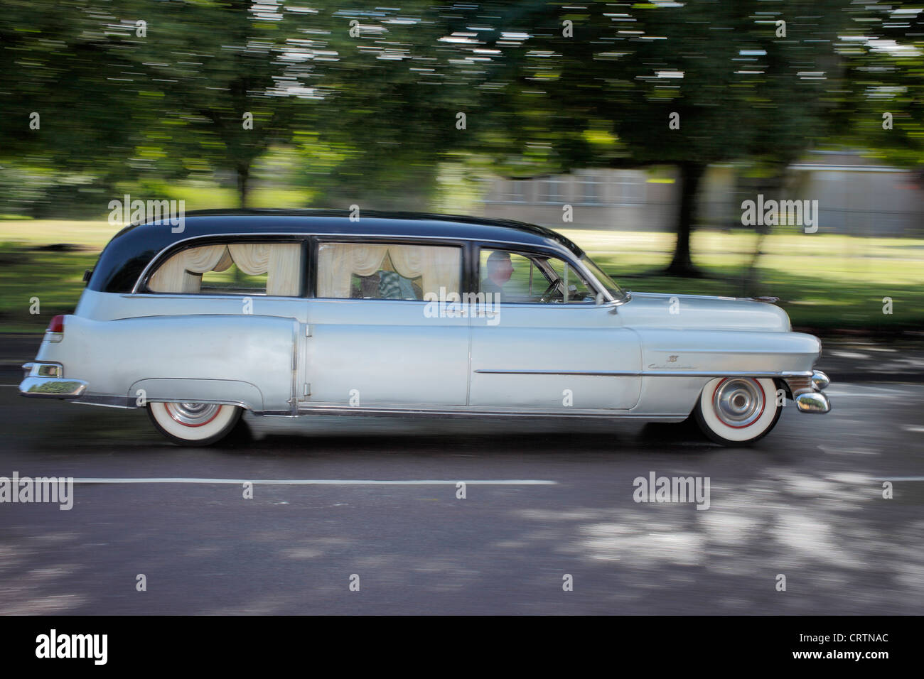 American 1952 Cadillac hearse traveling at speed. Stock Photo