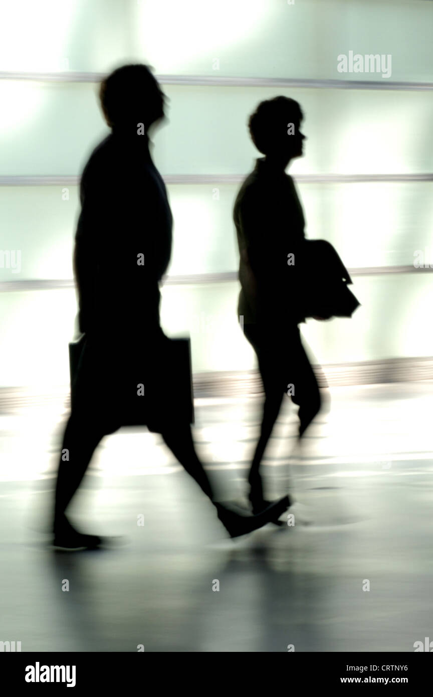 Silhouettes of a woman and a man with a briefcase Stock Photo - Alamy