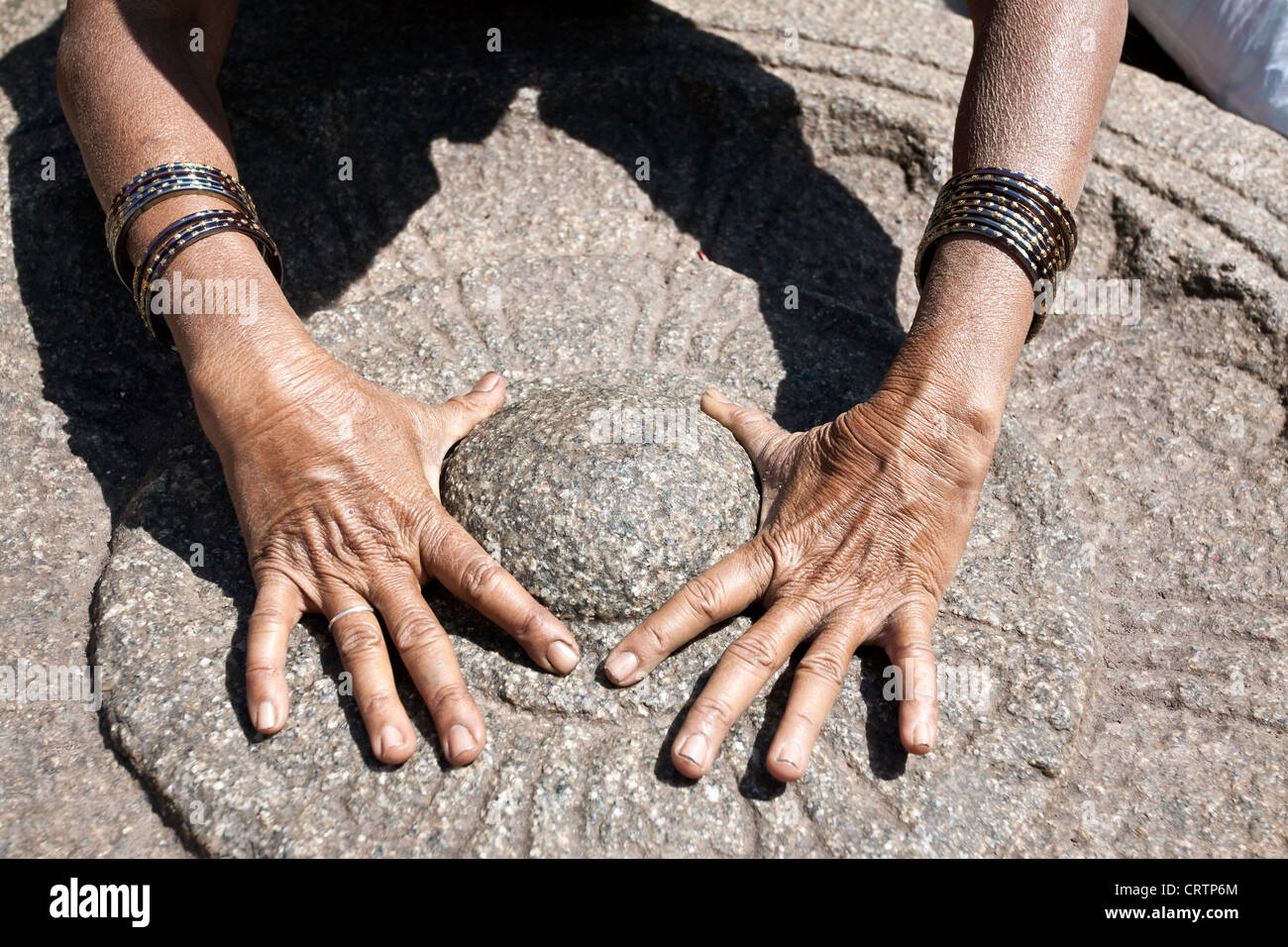 Woman worshiping a sacred stone. Virupaksha temple. Hampi. India Stock Photo