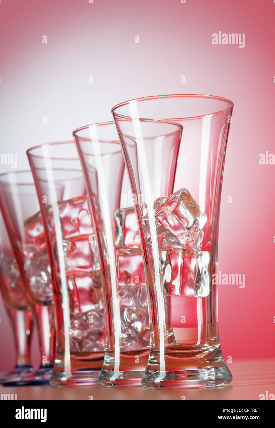 Glasses of water against gradient background Stock Photo