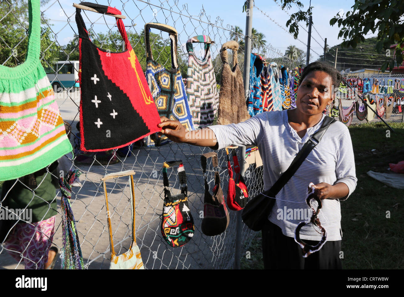 Trader offers traditionally bilum nets at a market in Madang, Papua New Guinea Stock Photo