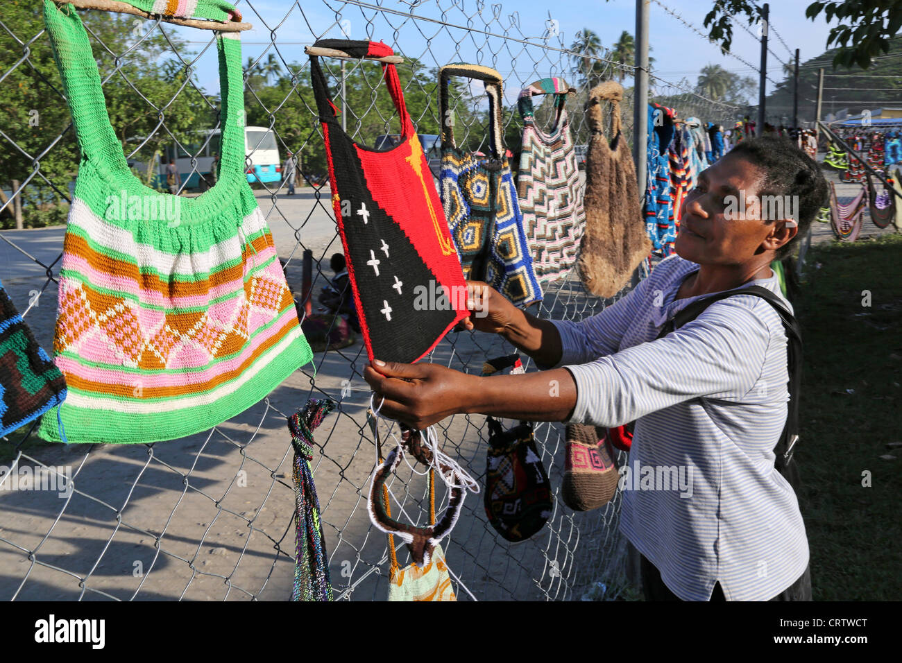 Trader offers traditionally bilum nets at a market in Madang, Papua New Guinea Stock Photo