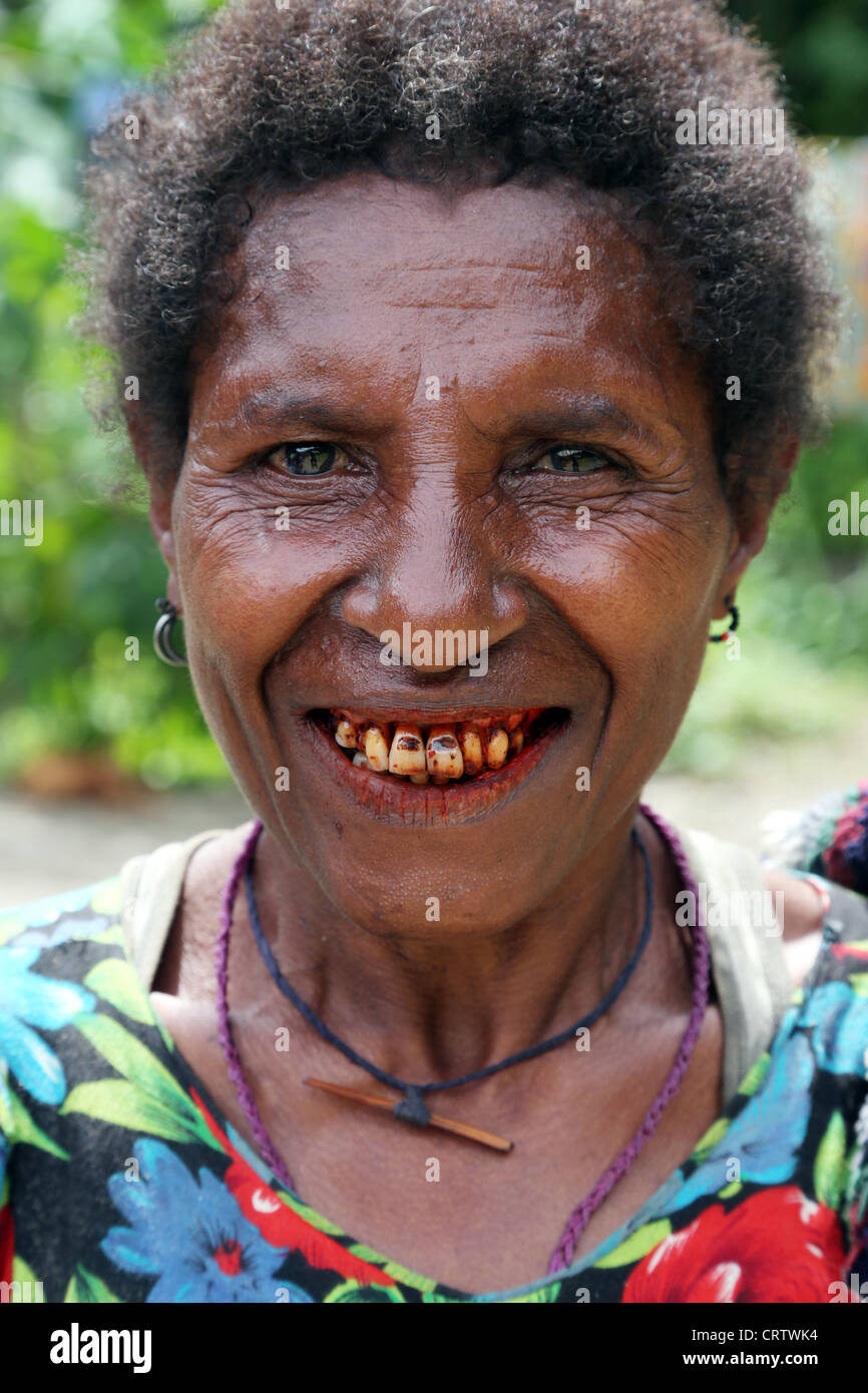 Woman with red teeth from chewing betel nut, highlands of Papua New Guinea Stock Photo