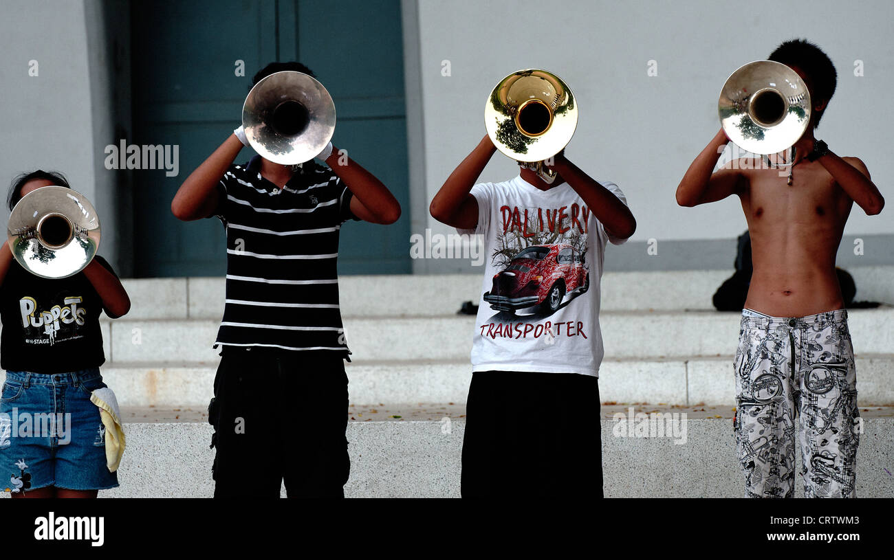 Group of young Thai boys and girls playing in a brass band in Lumpini